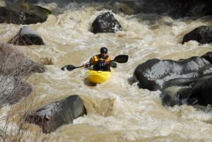 kayaking in the river rapids