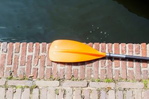 an orange paddle near sea