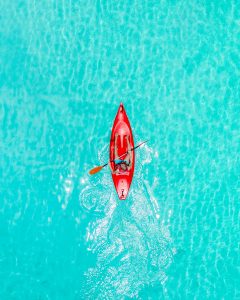 a kayaker in a transparent sea