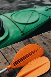 orange paddlers and a green kayak